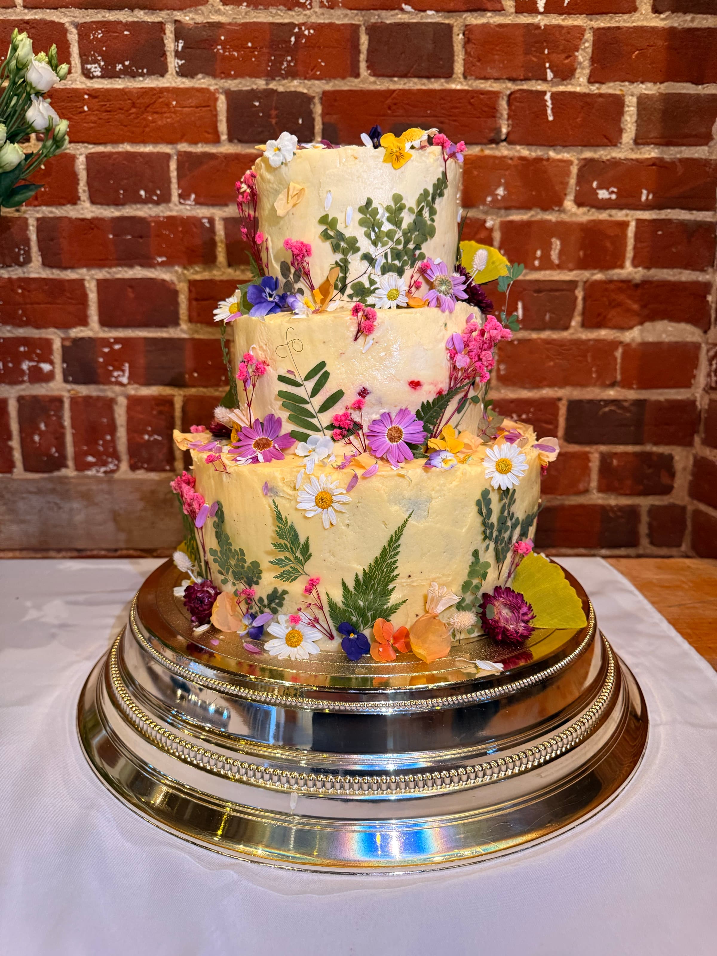 The Wedding Cake — pressed flowers · three tiers