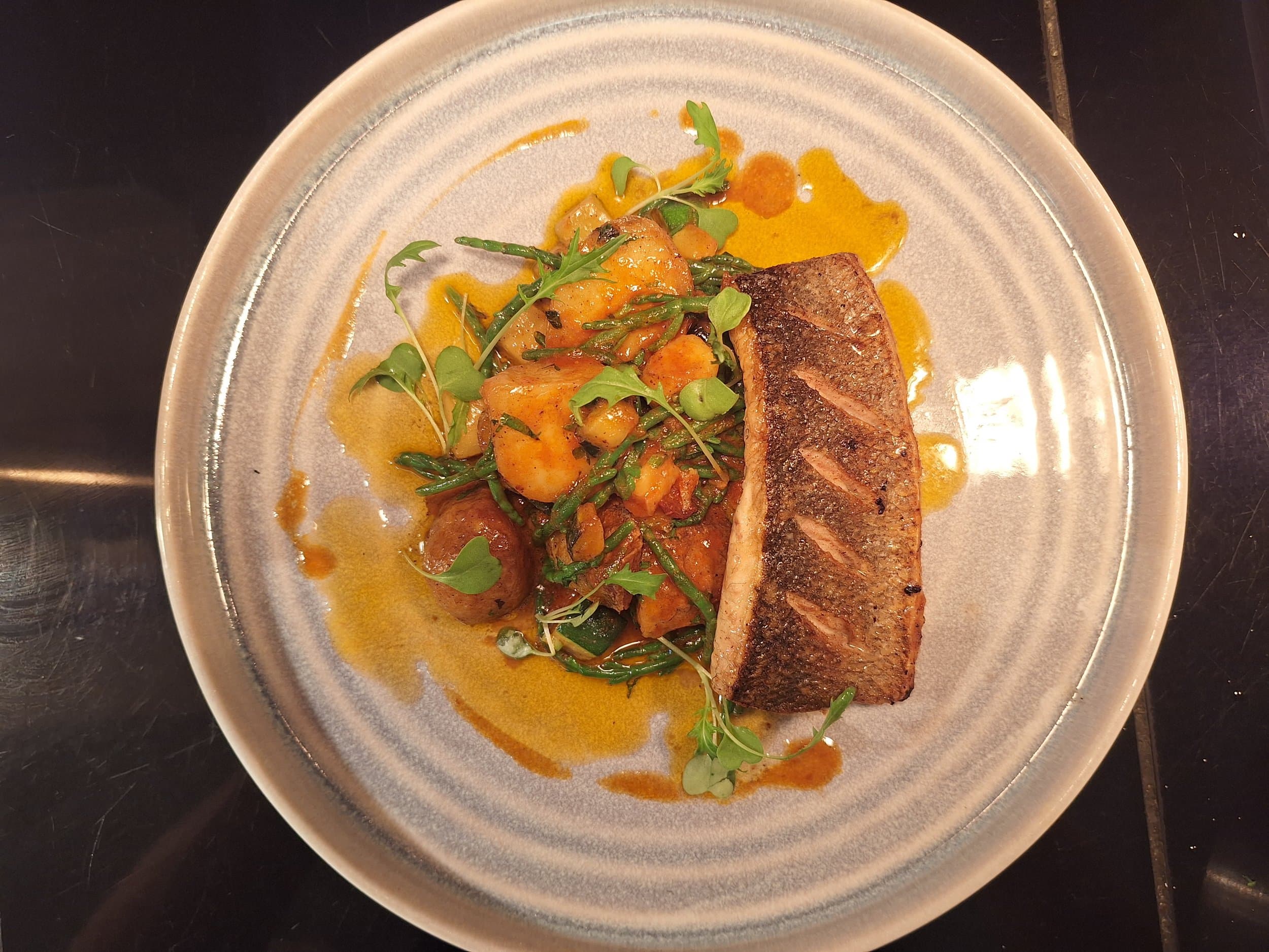Seared fish with vegetables, cleanly plated