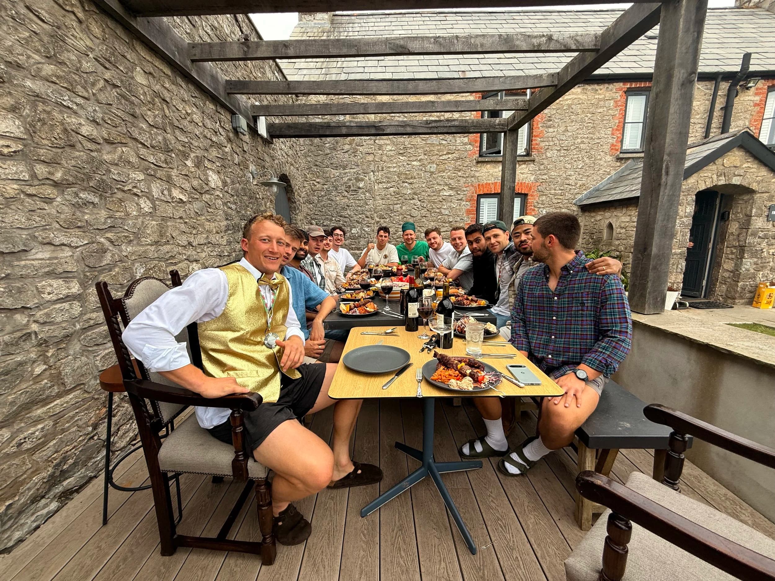 Guests at a long outdoor table in the afternoon light